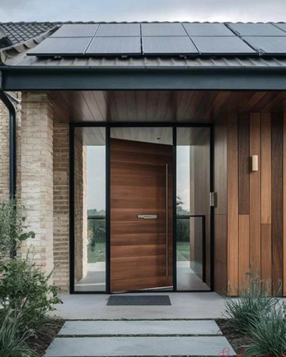 Red Walnut Horizontal Grain Pivot Door on a Brick Facade — product code BY-296