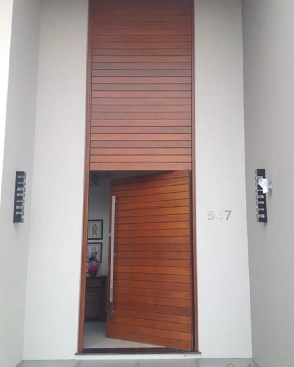 Walnut Pivot Door with Horizontal Grain in a White Niche — product code BY-183