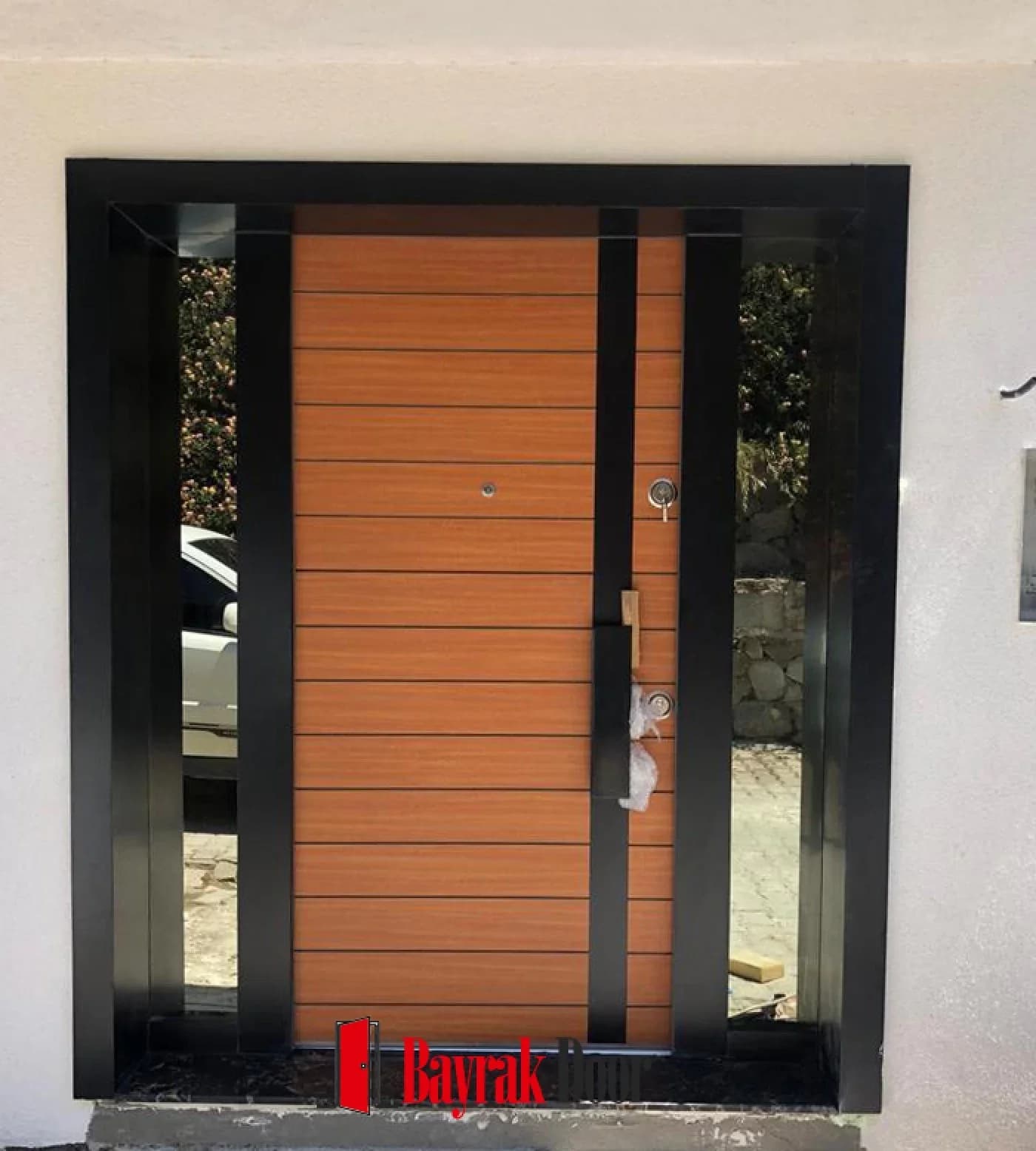 Horizontal Slat Orange Honey-Toned Villa Door BD-TR69 — Honey-toned horizontally slatted leaf in a black frame with narrow vertical sidelights
