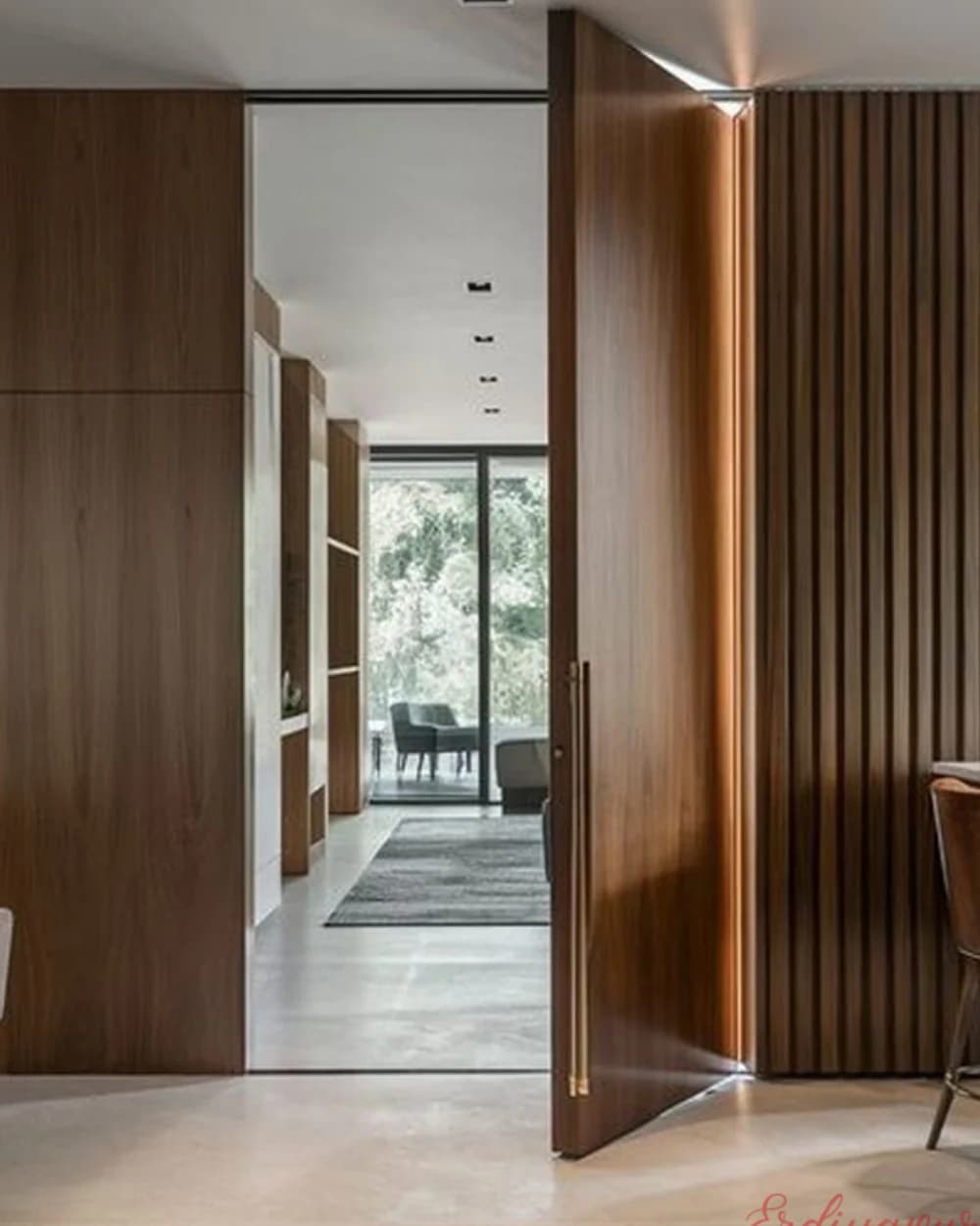 Walnut Vertical Slat Pivot Door at a Corridor Entrance — product code BY-229